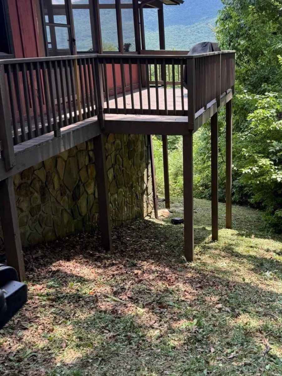 Cleared, tidy ground under a deck after a CLB property cleanup